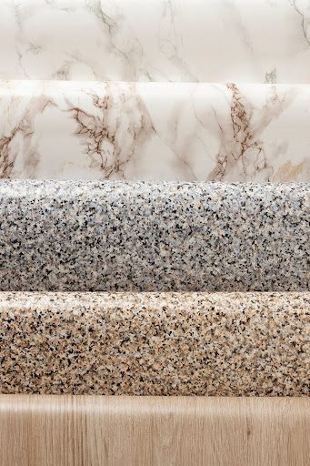 Close-up comparison of quartz and granite countertops in a modern kitchen