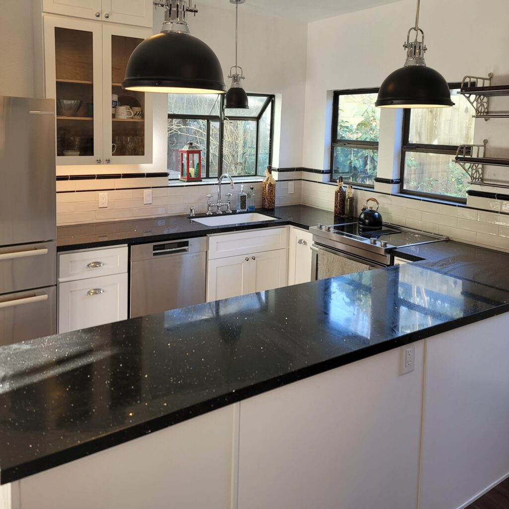 Bright remodeled kitchen with pendant lighting and wrap-around counters.