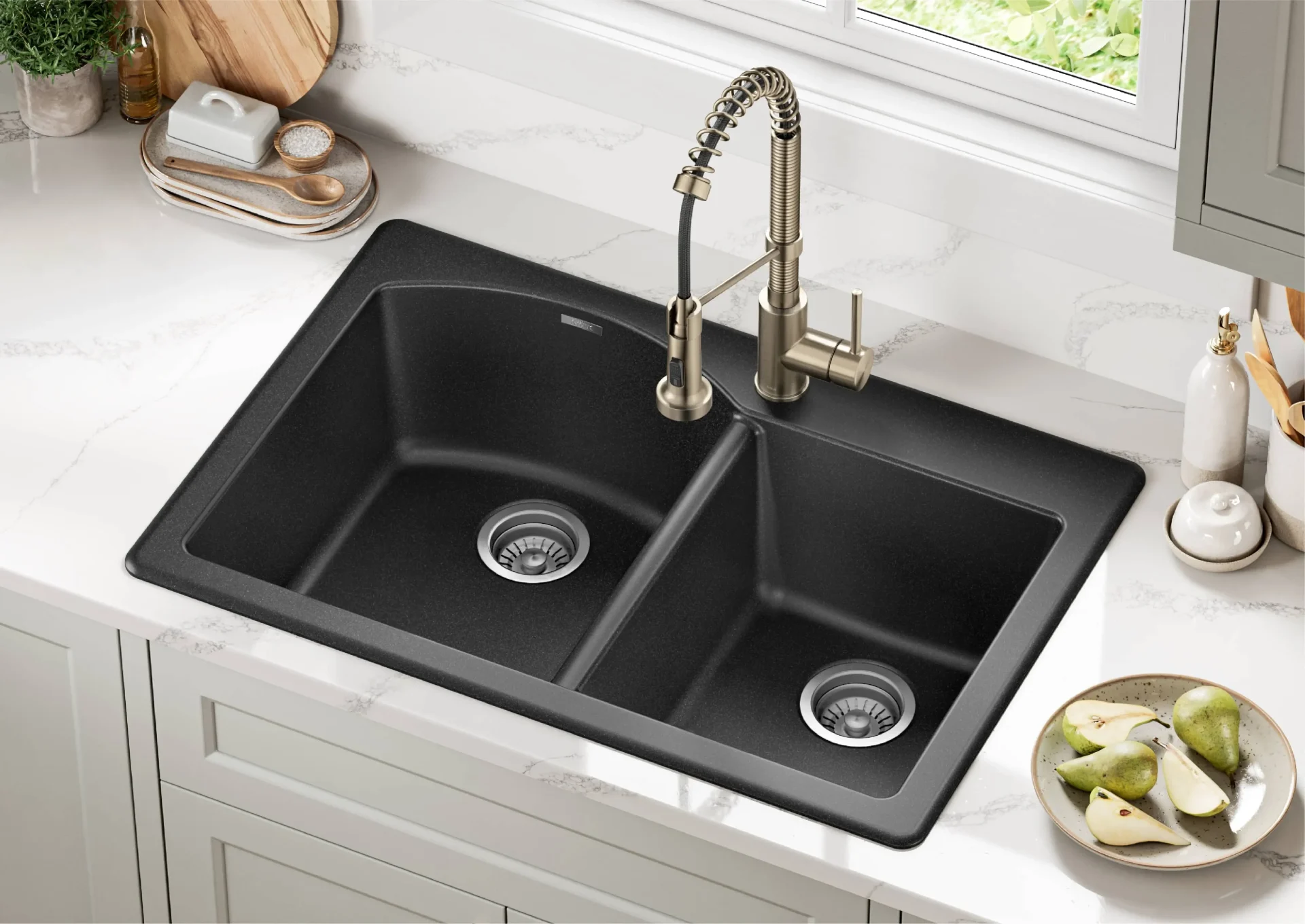  Black drop-in kitchen sink with a bronze faucet.