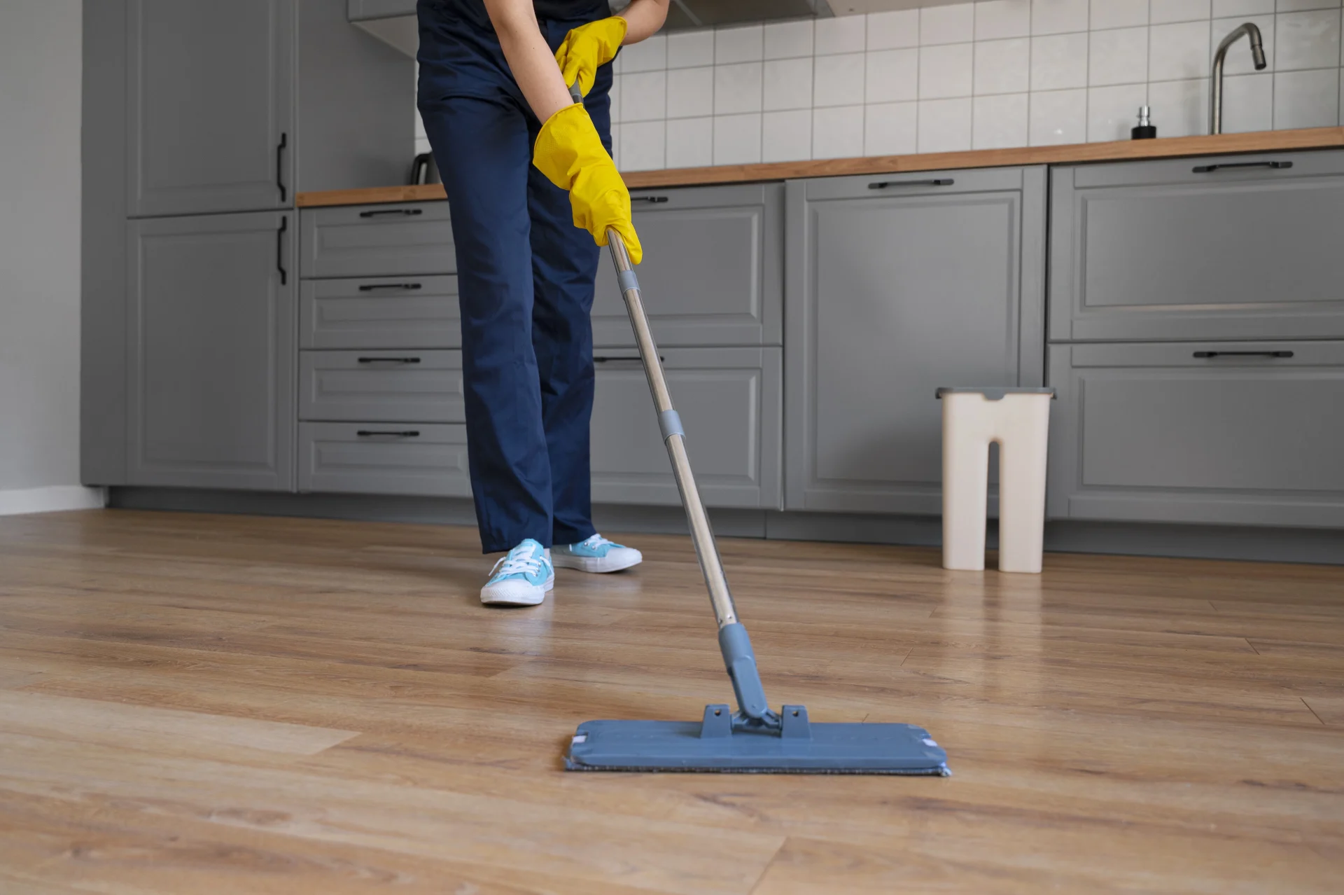How to clean floors after installation. Person cleaning newly installed hardwood floor with a microfiber mop