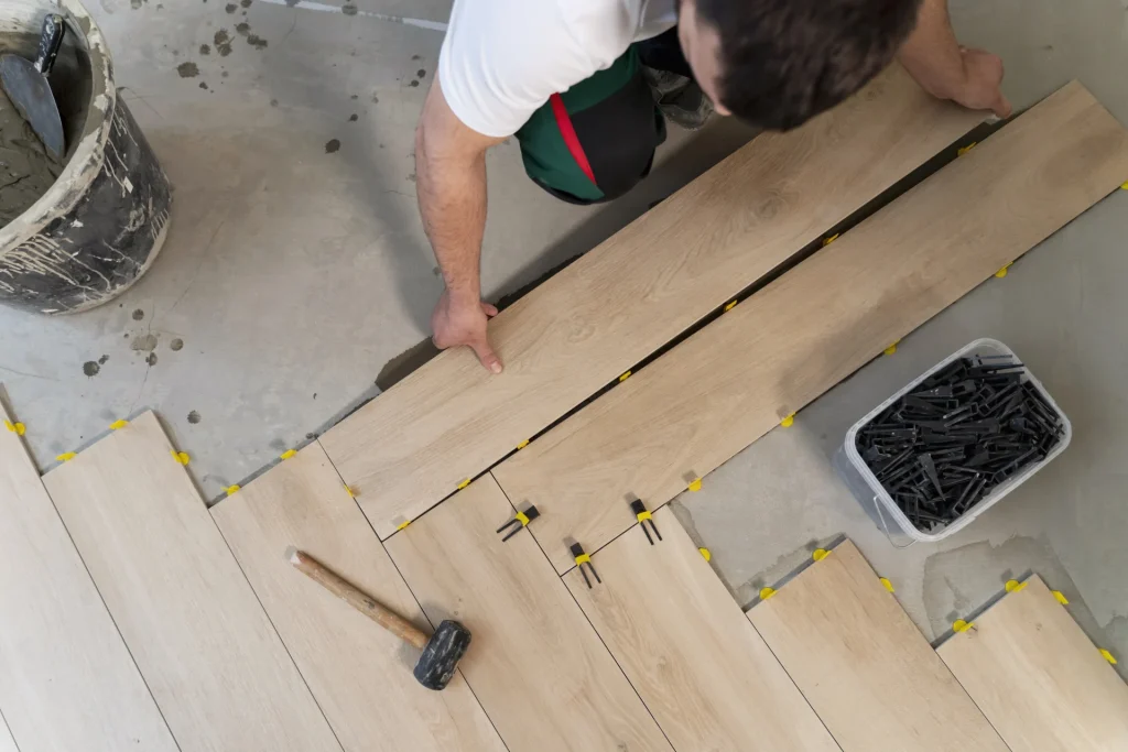 What are the different types of flooring materials . Professional installing engineered hardwood flooring using click-and-lock method