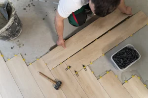What are the different types of flooring materials . Professional installing engineered hardwood flooring using click-and-lock method