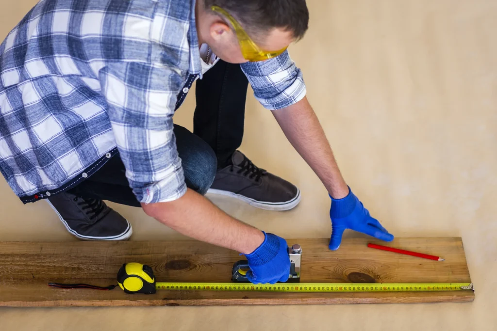 What should i do before installing new flooring. Homeowner measuring floor dimensions before installing new flooring